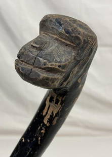 Carved Gorilla Head Cane: Striking cane featuring a carved gorilla head handle with expressive detail, on a knotty wood shaft with a black finish. Measures approximately 35''L. Some wear to the finish consistent with age.