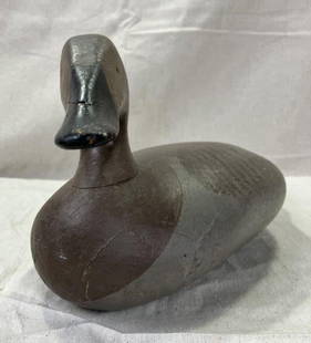 Canvasback Hen Duck Decoy: Solid wood decoy with finely painted details capturing the subtle coloration of a canvasback hen. Traditional form with appealing folk craftsmanship. Measures approximately 7''H x 6 1/2''W x 15''D.