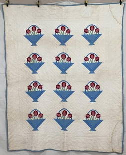 Handmade Appliqued Quilt with Tulips in Baskets: Charming and skillfully executed, this appliquéd quilt features twelve basket blocks, each containing two-toned tulips in shades of red and pink, arranged in a symmetrical grid on a crisp white