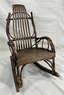 Child's Amish Twig Rocking Chair: Charming rustic rocking chair featuring a multi-board seat with twig frame construction and bent twig arms. Displays traditional Amish craftsmanship with a warm, natural finish. Measures