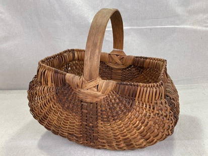 Splint Oak Market Basket: Beautifully woven basket featuring rich color variations throughout the splint weave. Fitted with a sturdy oak handle and well-balanced form. Measures approximately 12''H x 10''W x 10 1/2''D. Good