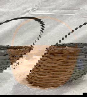 American Splint Oak Gathering Basket: Round form with finely woven splint oak and a sturdy arched handle. Warm, natural patina with traditional craftsmanship. Measures approximately 7 1/4''H x 8'' in diameter. Good condition with light