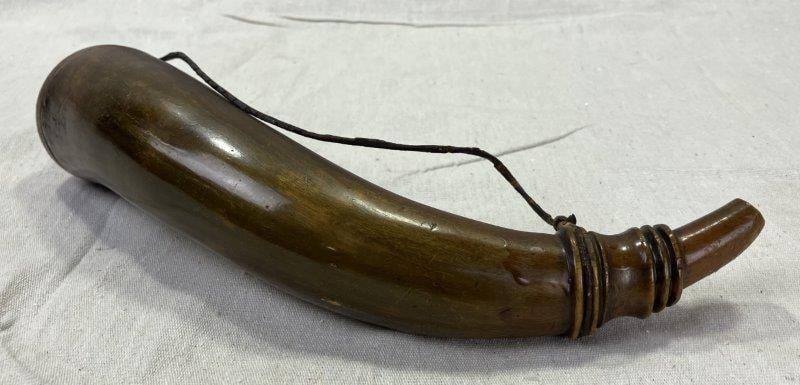 Powder Horn: Traditional form with smooth surface and warm patina. Fitted with a wooden cap and measuring approximately 10 1/2''L. Good condition with age-appropriate wear. Shipping available.