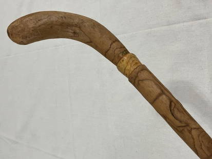 Folk Art Carved Ash Cane: Hand-carved folk art cane crafted from ash, featuring a curved handle and a gently tapered shaft adorned with acorn and plant motifs. Dated 6-6-83, this piece showcases detailed craftsmanship and