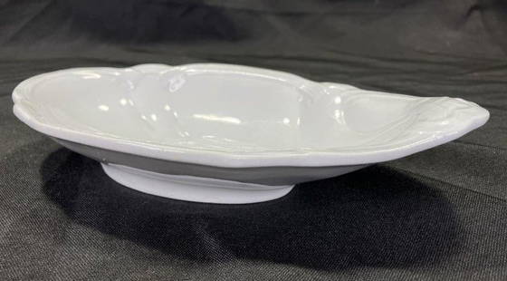 Ironstone Shell-Form Dish: Graceful shell-shaped ironstone dish with elegant curves and a subtle raised rim. Marked on the base by the maker. Displays gentle crazing consistent with age. Measures 1 5/8''H x 5''W x 8 3/4''L.