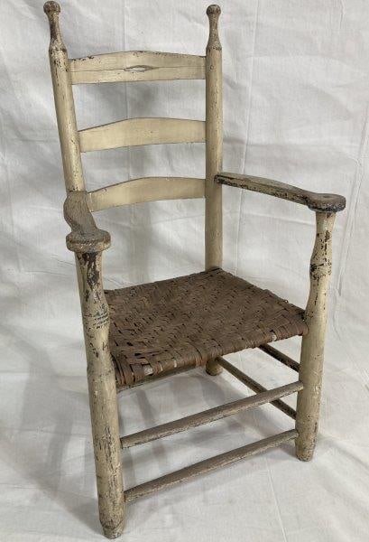 19th Century Southern Painted Armchair: Early Southern armchair retaining traces of its original white painted surface. Features shaped splats and arms, turned posts, and a woven seat. Legs have been reduced, with expected wear to the finis