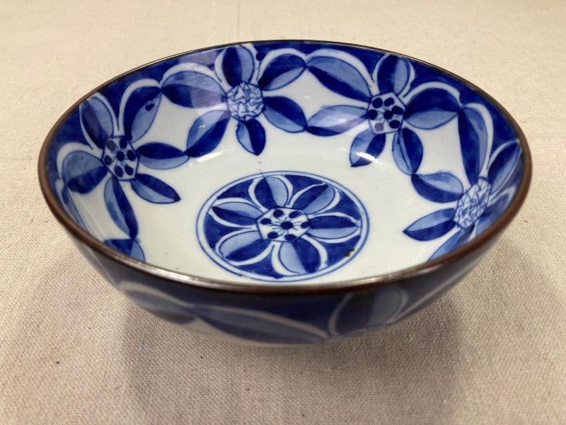 Japanese Blue and White Porcelain Bowl: Elegant Japanese porcelain bowl decorated in classic blue and white with a delicate floral motif. Measures approx. 3''H x 6 5/8'' in diameter. Good condition. Shipping available.
