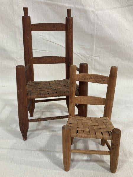 Pair of Miniature Country Chairs: Charming pair of miniature country chairs, one in a dark finish and the other in a lighter tone. Largest measures approx. 13 1/2''H x 7''W x 5 1/2''D. One chair shows slight wood loss. Shipping availa