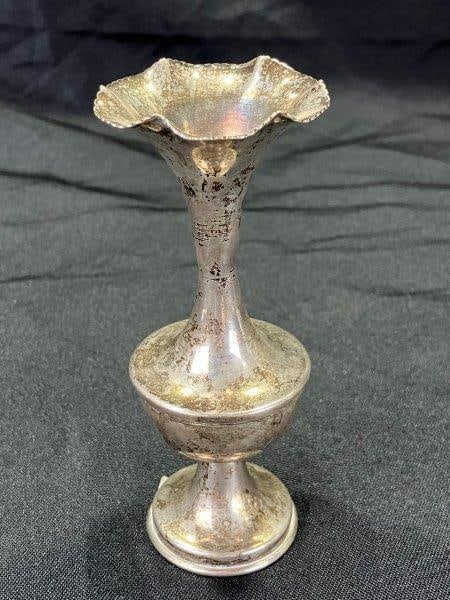 Sterling Silver Bud Vase: Delicate form with a ruffled edge and slender profile. Measures approx. 5 1/8''T x 2 1/8'' diameter. Good condition with some tarnishing. Shipping available.