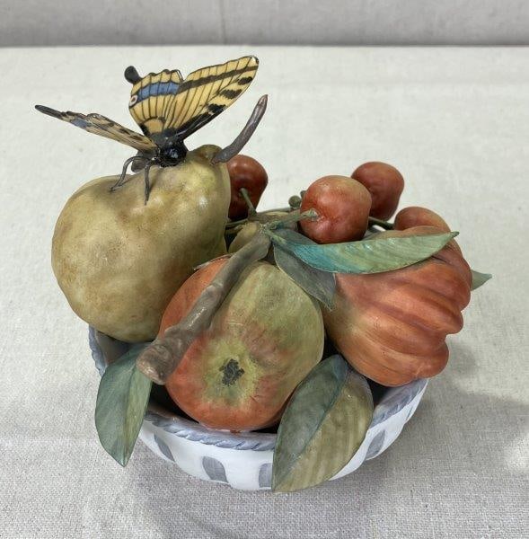 Capodimonte Porcelain Fruit Bowl: Charming hand-painted Capodimonte porcelain centerpiece featuring a vibrant arrangement of fruit topped with a delicate butterfly. Rich in color and detail, showcasing classic Italian craftsmanship. M