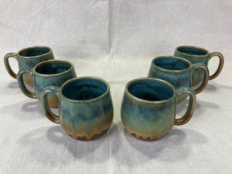 Set of Six W.J. "Bill" Gordy Art Pottery Mugs: Beautiful set of six handmade mugs by W.J. "Bill" Gordy, featuring a stunning glaze blend of blues, greens, and browns with rich depth and variation. Each is stamped "Hand Made by W.J. Gordy" on the b