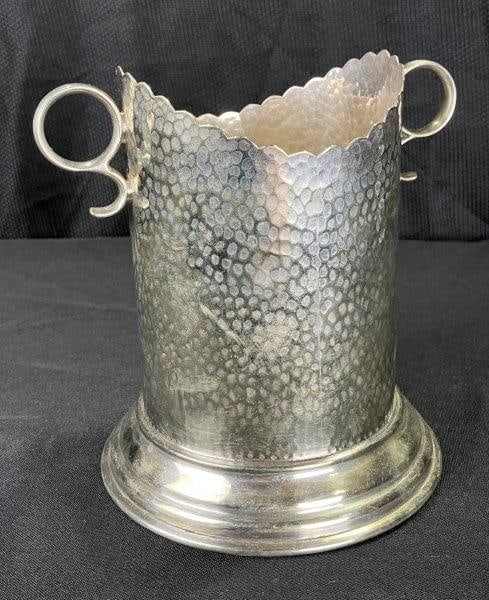 James Dixon Hammered Silverplate Wine Coaster: Elegant silverplate ice bucket featuring a hammered repoussé surface with circular scrolling handles. Marked on the underside with English hallmarks, including the trumpet symbol of the James Dix