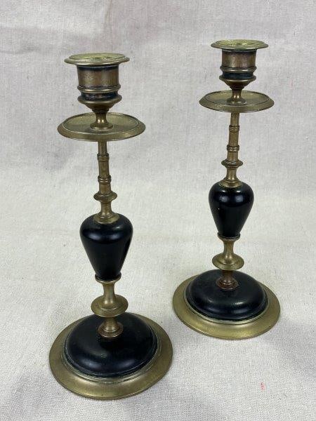 Brass and Stone Candlesticks: Elegant pair of cast bronze and crafted stone candlesticks, each with a classic form. Measures approximately 9 5/8''T x 4'' in diameter. Some tarnishing, particularly to the interior, consistent with