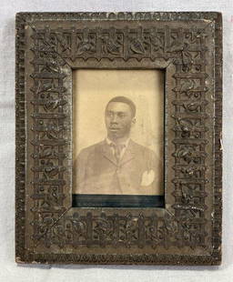 Early Photograph of African American Man: Vintage portrait of an African American gentleman likely late 19th to early 20th century set within an ornate wooden frame. Frame measures approximately 11''H x 9'W x 1''D and features elegant