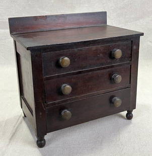 Late 19th Century Miniature Chest: Charming miniature chest featuring three drawers and a warm, rich mahogany finish. Showcasing fine proportions and period craftsmanship. Measures approximately 9'' H x 9 1/2'' W x 5 1/2'' D. Good