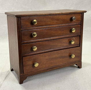 Mahogany Inlaid Miniature Chest: Classic form with four drawers, brass pulls, and bracket feet, featuring fine inlay detailing. Measures approximately 7 7/8'' H x 9 1/4'' W x 4 1/2'' D. Condition: Good with some light wear to the