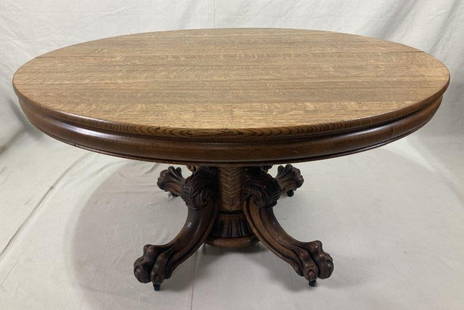 Highly Carved Quarter-Sawn Oak Dining Table: A richly detailed example featuring deeply carved paw feet, a fluted center column, and bold quarter-sawn oak grain throughout. Stately proportions and superb craftsmanship make this a standout piece
