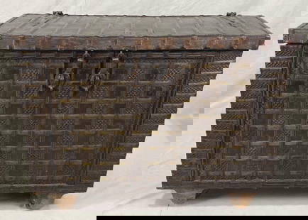 Large Wooden Damchiya Dowry Chest with Embossed Metalwork: A striking traditional Indian dowry chest, richly adorned with embossed mixed-metal panels and bold wrought iron hardware. Raised on wooden casters, this Damchiya features intricate craftsmanship and
