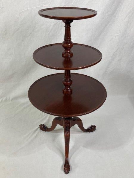 Mahogany Three-Tier Dumbwaiter Table: Graceful circular tiers supported by finely turned columns, terminating in classic carved claw feet. Approx. 44" H x 23" in diameter. Good condition.