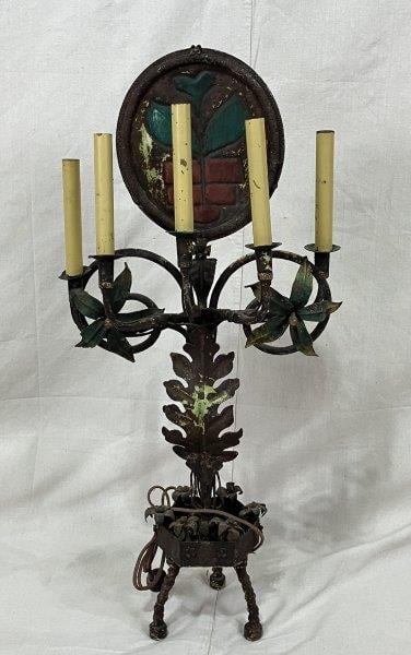 Antique Painted Wrought Iron Candelabra: An eye-catching antique candelabra featuring vibrant red and green painted accents on the top medallion, with stylized vegetal leaf forms cascading along the body and base. Measures approximately 32 3