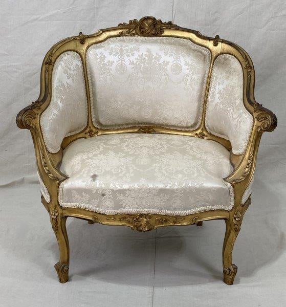 Carved French Giltwood Chair: Elegant and finely detailed, this French-style chair features a carved giltwood frame with classical motifs and white upholstery. Measures approx. 32 1/8''T x 30 3/8''W x 22''D. Floor to seat 15''. So