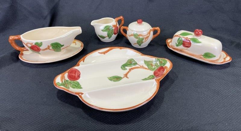 Franciscan Apple Serving Pieces: Charming group of Franciscan dinnerware in the iconic Apple pattern, including cream and sugar set, gravy boat, butter dish, and serving tray. Largest piece approx. 1 1/2" H x 12" W x 9 3/4" D. Each p