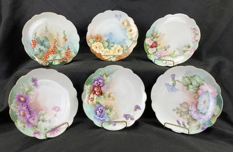 Set of Six Hand-Painted Floral Plates: Charming assortment of hand-painted plates featuring roses, pansies, and other floral motifs. Various makers, each with delicate brushwork and vibrant color. Each plate measures approx. 7 3/4'' in dia