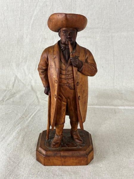 Finely Carved Continental Gentleman: Expertly carved figure of a gentleman with a pipe, showcasing intricate facial detail and fine craftsmanship. Maker’s mark stamped on the base. Measures approximately 11" H x 4 1/4" W x 3 1/2" D