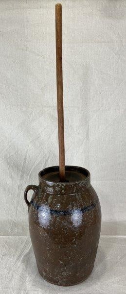 South Carolina Stoneware Churn: Features a rich brown glaze with a cobalt ring along the top, complete with lid and churn staff. Applied handle and robust curved form, attributed to Joe Johnson, Laurens, South Carolina. Crock withou