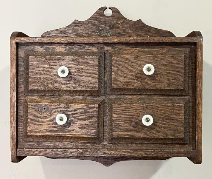 Miniature Oak Wall Chest: Features elegant white turned knobs and a scalloped bonnet top for added visual interest. Measures 11 1/2" H x 13" W x 7 3/8" D. Good condition with minor wear.