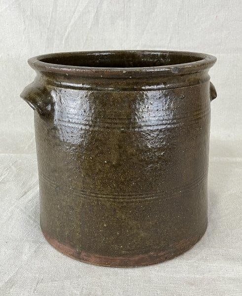 Alkaline Glaze Crock with Line Decoration: Straight-sided stoneware crock with applied lug handles and incised line decoration, likely of Southern origin. Measures approximately 9 3/8" H x 10" W x 9 1/4" D. Good condition with minor age-approp