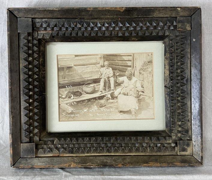 Black Americana Photograph in Tramp Art Frame, 1895: Photograph originating from the Russell Brothers studio of Anniston and Calhoun County. This poignant period image captures a rare glimpse into African American life at the time, depicting a woman dis