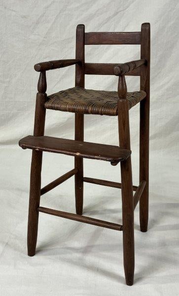 Turned High Chair with River Cane Seat: Traditional turned high chair with a warm aged patina and a finely woven rivercane seat. Measures approximately 32 3/8'' H x 15 3/8'' W x 24 1/4'' D. Good condition with age-appropriate wear.