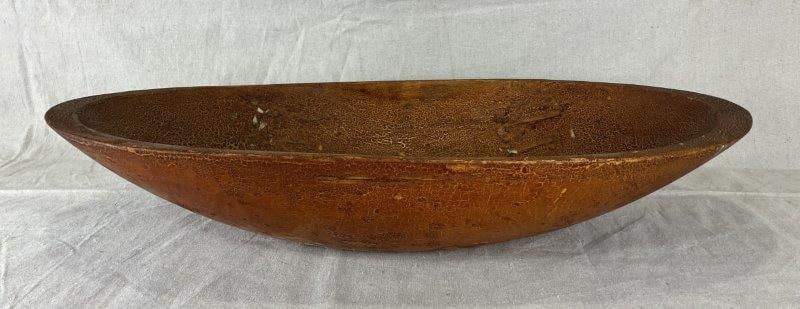 Carved Dough Bowl: Carved wooden oval dough bowl featuring an attractive alligator finish and a warm, aged patina. Measures approximately 4 3/8" H x 24 1/2" W x 13 1/8" D. Good condition with light wear consistent with