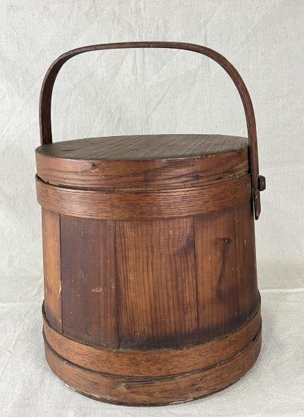 Country Pine Firkin: Charming country pine firkin with a warm aged patina, copper nails, and traditional wood banding. Measures approximately 11 1/2" H x 12 1/4" D. Good condition with some loss to the banding consistent