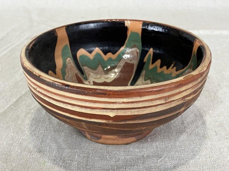 Southern Folk Pottery Bowl: Bowl with swirl ware glaze. Measures approximately 2 3/4" H x 5 3/8" in diameter. Good condition.
