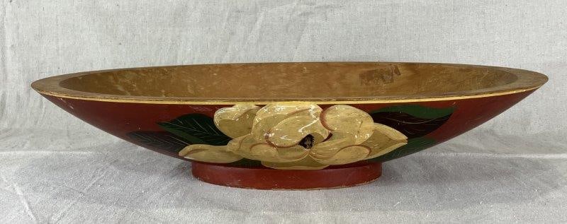 Decorated Oval Dough Bowl: Footed oval dough bowl with carved handles underneath and a floral motif at the center front. Measures approximately 4" H x 21 3/8" W x 11 1/8" D. Aged, used surface.