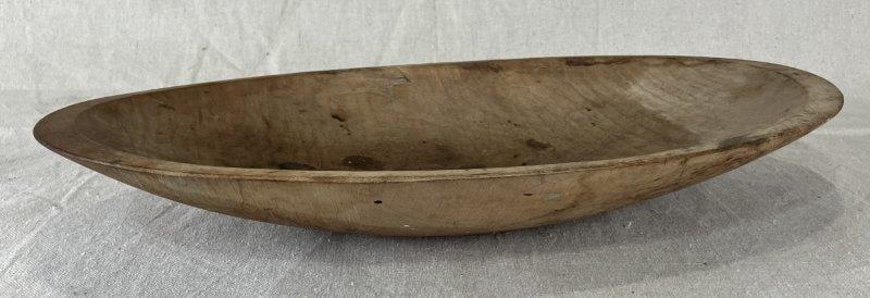 Oval-Shaped Dough Bowl: Hand-carved oval dough bowl with integral handles formed beneath the rim. Displays a warm, aged patina and subtle tool marks. Measures approximately 9 1/4" L x 4 3/4" W x 4" H. In good condition with 