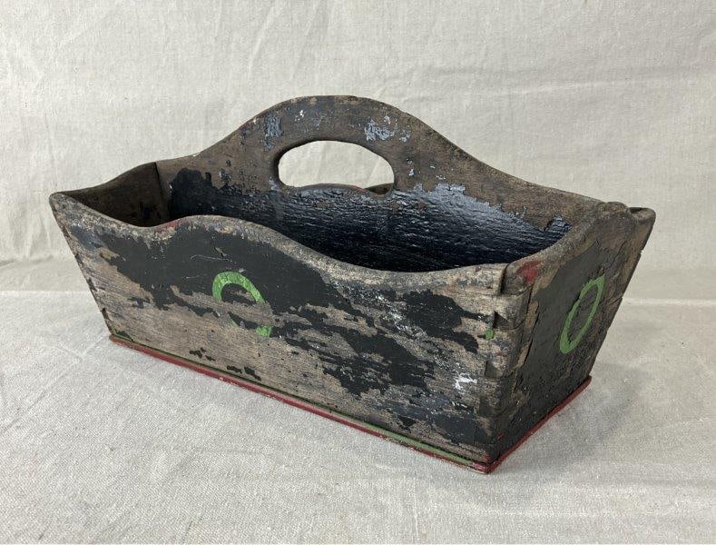 Wooden Silverware Caddy: Charming wooden silverware caddy featuring dovetail construction, a shaped handle, and traces of old red, black, and green paint. Measures approximately 8" H x 15 1/4" W x 8" D. Loss to some paint con