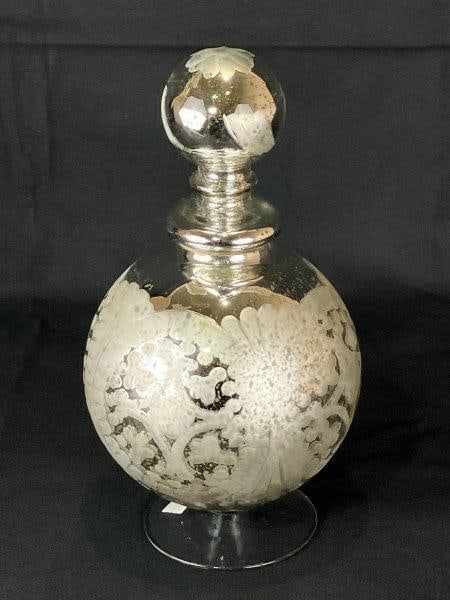 Etched Mercury Glass, 19th Century: Beautifully etched and patterned floral motif mercury glass with excellent light-reflective qualities, set on a glass base. Measures approximately 11" H x 5 1/2" in diameter. Good condition.