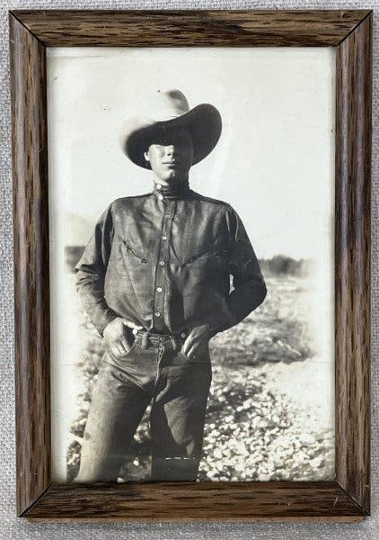 Early 20th Century Cowboy Photograph: Striking black-and-white portrait of a cowboy dressed in classic jeans and a button-up shirt, capturing the spirit of the American West. Measures approximately 5 1/8" H x 3 5/8" W x 3/8" D. Light crea