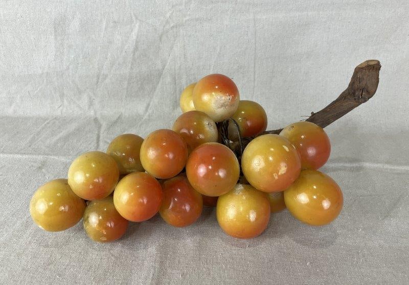 Cluster of Alabaster Grapes: Beautiful alabaster grapes in caramel and burnt orange tones, with wire construction and a natural wood stem. Measures approximately 6 1/2" H x 15 5/8" W x 8" D. Good condition with some loss to finis