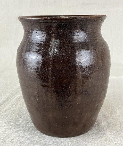 Georgia Stoneware Jar: Hand-thrown stoneware jar with rich, multi-toned brown glaze and strong Southern form. Marked by the maker, originating from Macon, Georgia. Measures approximately 7" H x 5 1/8" D. Good condition with