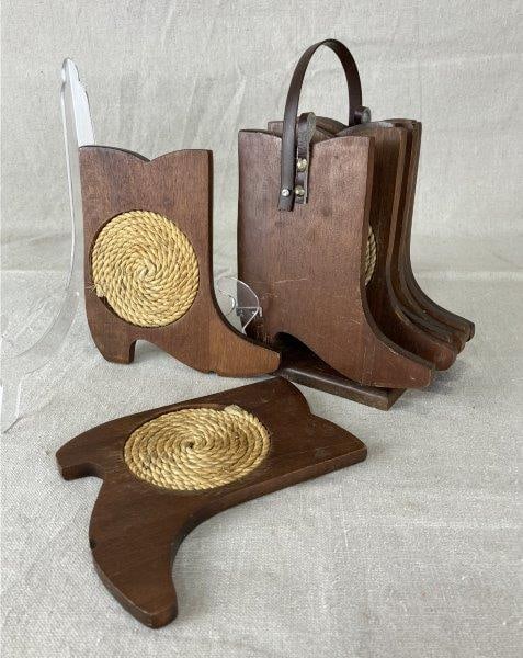 Cowboy Boot Coasters: Kitsch wooden coasters shaped like cowboy boots with round woven inserts for drinks and leather accents. Each measures approximately 7 3/8" H x 5 3/4" W x 3 1/4" D. Good condition with some wear to fi