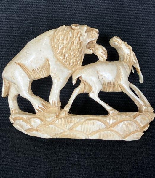 Bone Gazelle and Lion Carving: Intricately hand-carved bone scene depicting a male lion in pursuit of a gazelle, with finely detailed markings highlighting the musculature and movement of each animal. Measures approximately 2 1/2"