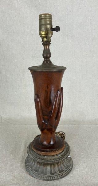 Folk Art Carved Hand Lamp: Carved mahogany sculptural lamp by the artist Christian, inscribed on the base and marked “Greetings for Pitcairn Island.” The lamp features a finely carved hand form supporting a cup, wit