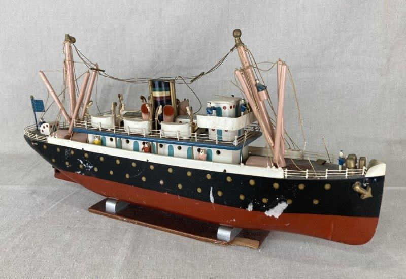 Folk Art Polychrome Ship Sculpture: Intricately hand-crafted and hand-painted folk art ship featuring numerous small carved passenger figures and finely detailed structural elements throughout. Rich polychrome decoration adds visual int