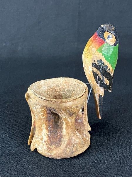 Folk Art Painted Wood Bird and Bone Sculpture: Artistically combines a carved and polychrome-painted wooden bird with bone used as a tree stump, creating a work of distinctive character and visual interest. Measures approximately 4" H x 3 3/4" W x