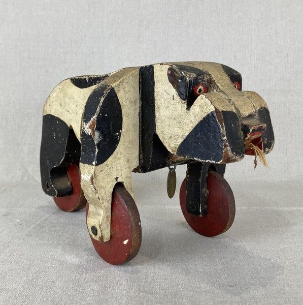 Warner Scott Bull Dog Pull Toy: Nostalgic childhood pull toy with a weathered surface and strong collectible appeal, produced in Lowell, Michigan. Features a brass tag stamped "Warner Scott," distinctive chipped paint, remnants of t