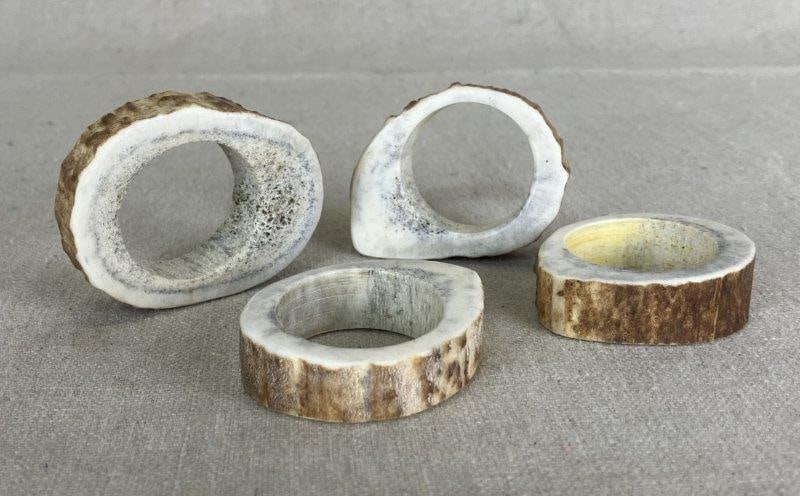 Antler Slice Napkin Ring Group: Set of four rustic napkin rings crafted from natural antler slices, each showcasing unique textures and tones. A handsome decorative grouping ideal for country or lodge-style settings. One measures ap